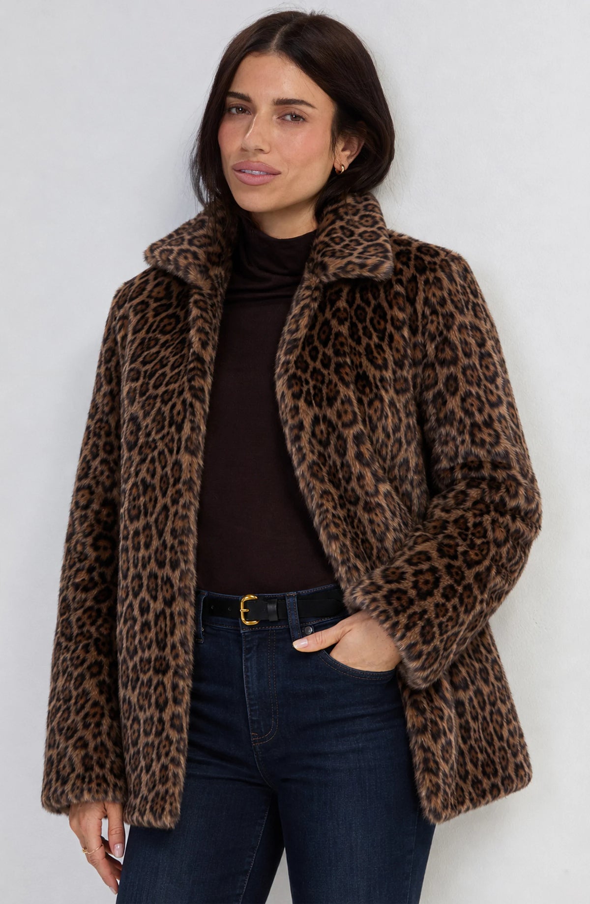 Woman wearing the Liverpool collared faux fur coat in brown multi leopard print with a stand collar and on-seam pockets.