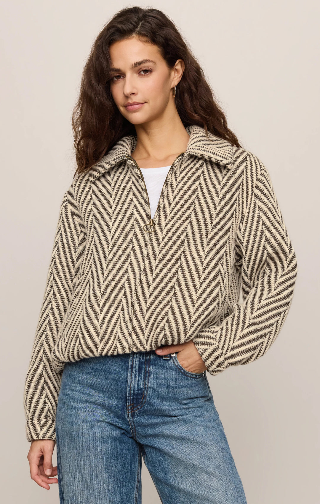 Woman wearing the Z Supply Dunaway bubble jacket in dark chocolate herringbone with an antique brass zip and sculpted bubble hem.