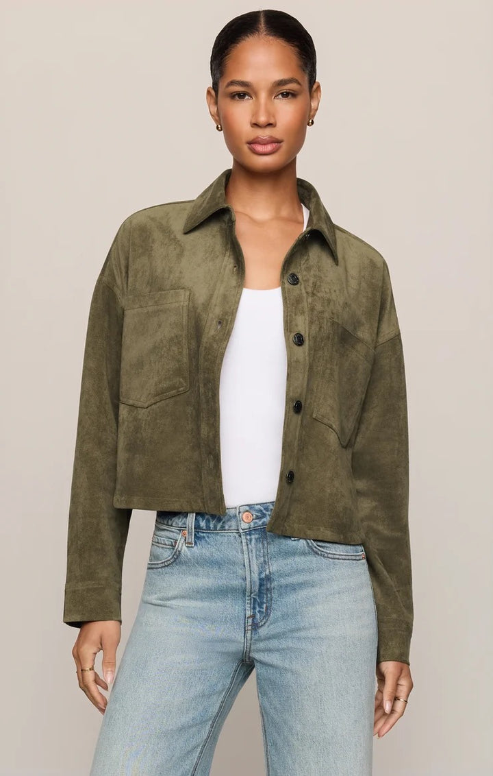Woman wearing the Z Supply All Day cropped faux suede jacket in monstera green with oversized patch pockets and a button front.